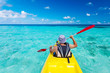 © Maygutyak - Young caucasian man kayaking in sea at Maldives