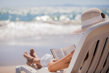 Relaxing And Reading At The Beach