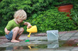 © endostock - White little barefoot girl playing with water