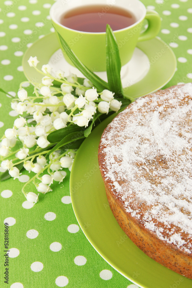 Delicious poppy seed cake with cup of tea on table close-up