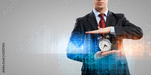 Fototapeta do kuchni Business man holding alarmclock