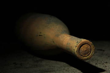 Canvas Print - Old bottle of wine in old cellar, on dark  background