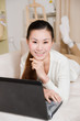 © robinimages - young asian woman using a laptop