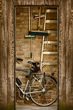 Retro Styled Image Of A Shed With A Bicycle Inside