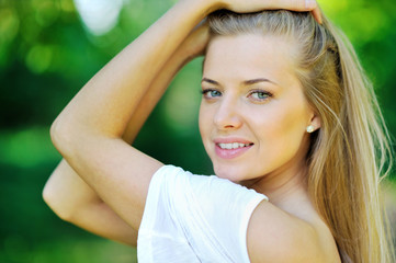 Portrait of a young beautiful woman on the nature - closeup