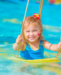 Wall Mural - Happy girl on water swing