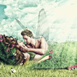 Loving fairy couple in a bed of grass