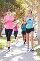 Wall Mural - Group Of Female Runners Exercising On Suburban Street