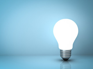 Poster - Light bulb standing on blue background with reflection