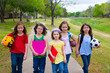 Children kid girls walking to schoool with sport balls