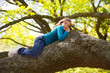 Children kid girl resting lying on a tree branch
