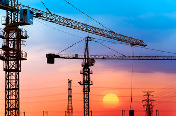 industrial construction cranes and building silhouettes