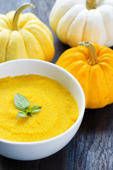 Canvas Print - Pumpkin porridge and pumpkins on black wooden table