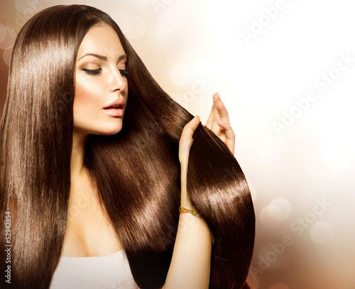 Obraz w ramie Beauty Woman touching her Long and Healthy Brown Hair