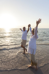 Wall Mural - Happy Senior Couple Walking Holding Hands Tropical Beach