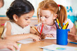 © spass - Cute preschoolers drawing with colorful pencils