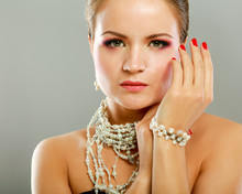 Portrait Of Pretty Young Woman With Beads And Bangle