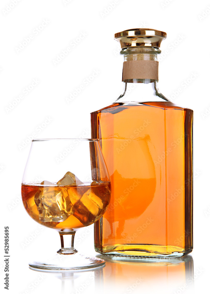 Glass of brandy and bottle isolated on white