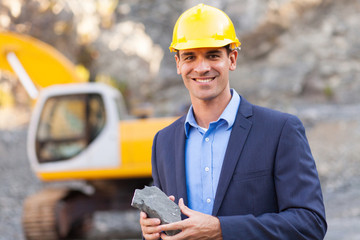 Wall Mural - manager in mining site holding ore