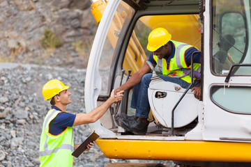 Wall Mural - construction manager handshaking with bulldozer operator