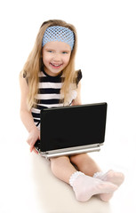 Wall Mural - Smiling cute little girl with laptop isolated