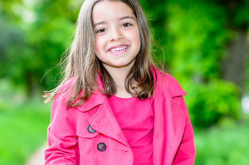 Wall Mural - portrait of happy cute child standing in a park