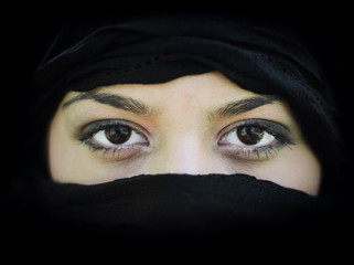 Portrait of beautiful Arab woman wearing black scarf