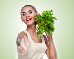 woman with bundle herbs (salad). Concept vegetarian dieting