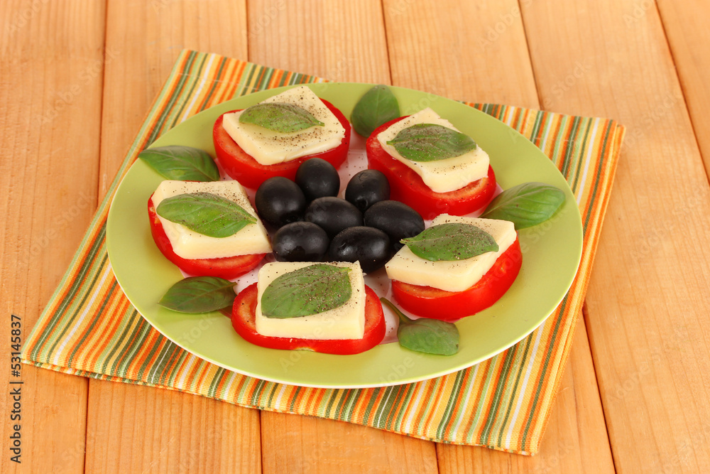 Cheese mozzarella with vegetables in plate on table