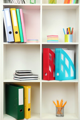 Wall Mural - White office shelves with different stationery, close up