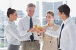 © WavebreakmediaMicro - Group of business people clinking their flutes of champagne