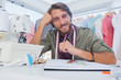 © WavebreakmediaMicro - Smiling designer working at his desk