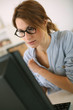 © goodluz - Girl with eyeglasses working in office