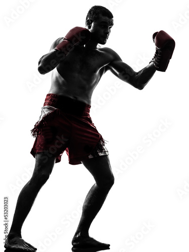 фотографія one man exercising thai boxing silhouette