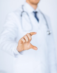 Wall Mural - male doctor holding something in his hand