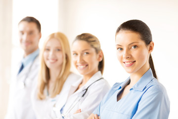 Poster - female doctor in front of medical group