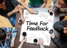 Time For Feedback Written On A Poster With Drawings Of Charts