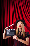 Fototapeta Tulipany - Woman gangster with movie clapper