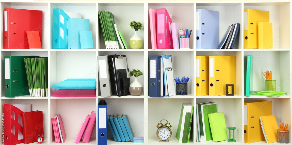 White office shelves with different stationery, close up