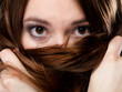 © Voyagerix - Closeup woman covers the face by long brown hairs