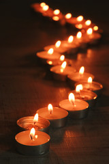 Wall Mural - Burning candles on dark background