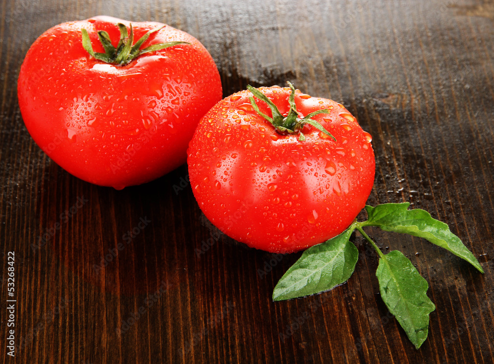 Fresh tomatoes on wooden background