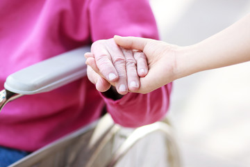 Wall Mural - Senior Lady in Wheelchair Holding Hands