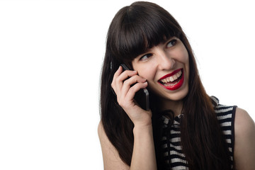 Smiling spanish girl talking by phone