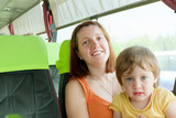 Fototapeta  - Mother and child traveling in commercial bus