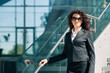 © pio3 - Business woman portrait outdoors with modern building