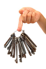 Bunch Of Old Keys In Hand Isolated On A White Background.