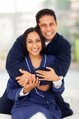 Wall Mural - happy indian couple hugging on bed