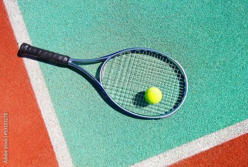 Fototapeta na wymiar Close up of tennis racquet and ball on the tennis court