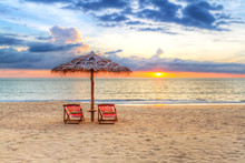 Sunset Under Parasol On The Beach In Thailand